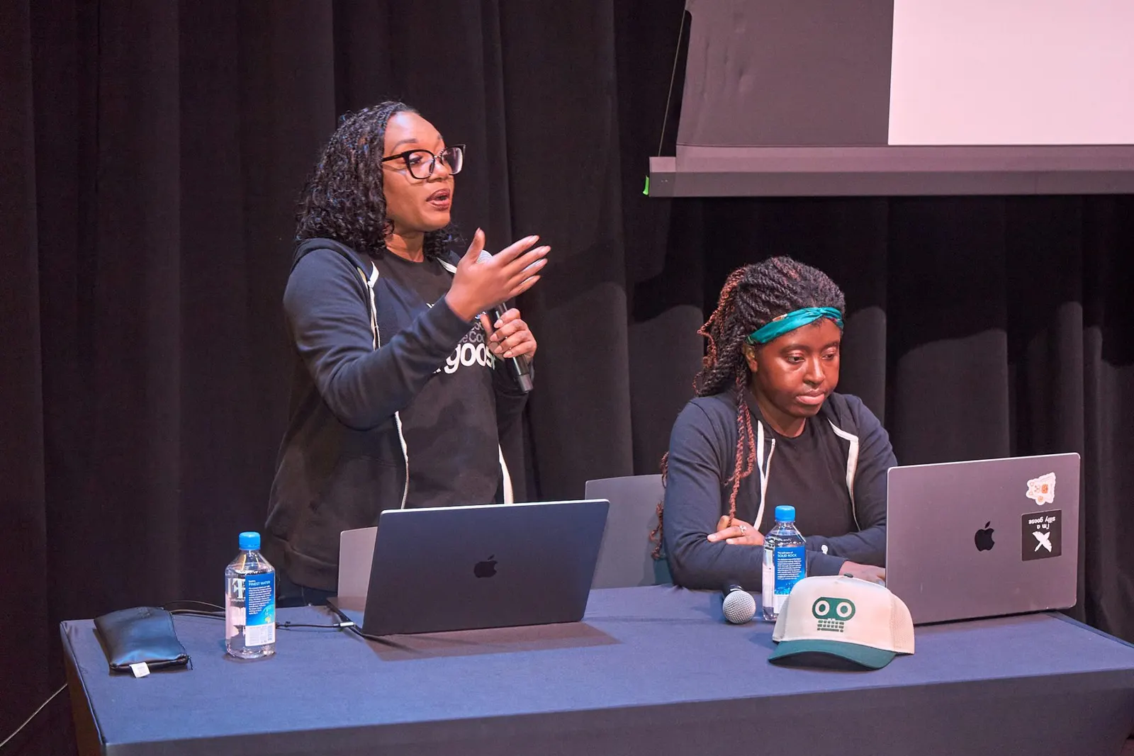 Two engineers presenting their work on stage
